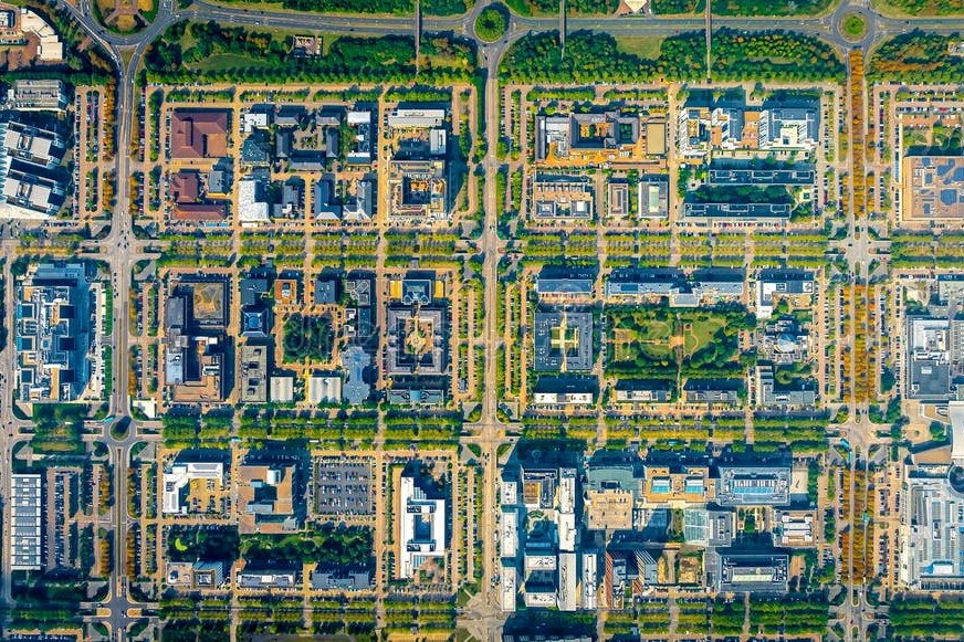 Central Milton Keynes from directly overhead, its grid of boulevards and tree lines.
